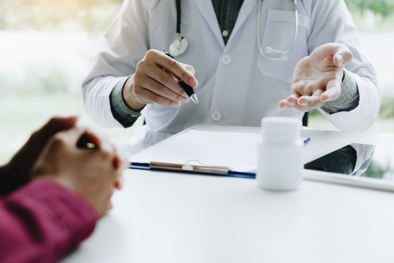 A doctor discusses menopause treatments with a patient.