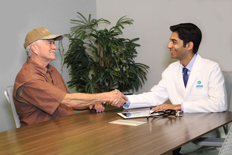 Dr. Aleem Kanji shakes the hand of a satisfied patient at Ethos Endocrinology in Houston, Texas.