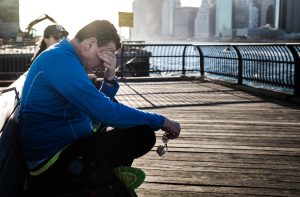 Tired man sitting on a bench