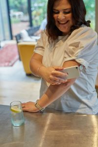 Woman scanning glucose monitor