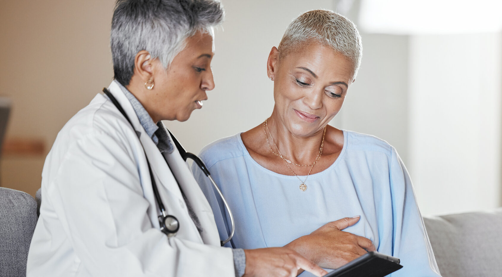 Tablet, consulting or pregnant woman with doctor for medical check or monitor pregnancy healthcare progress. Digital, maternity or senior worker talking, speaking or helping patient with baby advice