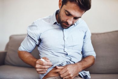 A young man with Type2 diabetes injects himself with insulin.