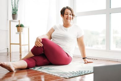 A woman stays healthy with light yoga exercise on the floor.