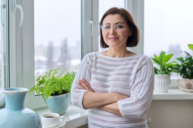 A woman with menopause smiles at the camera.